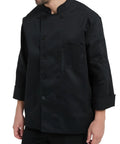 Straight Fire Kickass Chef Coat Black Long Sleeve Kitchen Workwear worn by a male chef with practical pocket detail.