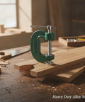 Heavy Duty G Clamps For Woodworking And Welding Use, Alloy Steel workholding tool securing wood pieces on a workbench.
