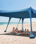Rock Solid Beach Canopy Tent 10x13 Ft With Ten Sandbags And 22mm Thick Aluminum Poles on a sunny beach with family underneath