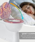 Slow Close Elongated Toilet Seat for Bathroom on white toilet, featuring colorful marbled design, showcasing slow closing feature.