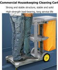 Heavy Duty Rolling Cleaning Cart Built Like A Tank For Busy Hotels And Commercial Spaces Featuring Super Smooth Casters And Hella Large Storage Compartments Made To Get The Job Done Right Every Single Time with two people standing next to it.