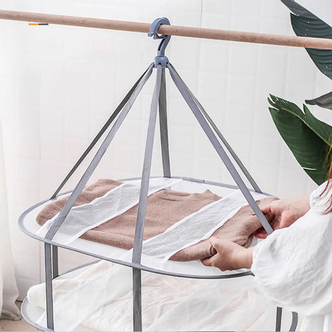 Three Tier Mesh Clothes Drying Rack With Foldable Sweater Hanger For Zero Sweat Quick Dry Setup And Hella Sturdy Heavy Duty Home Laundry Portable Solution with brown sweater.