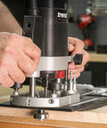 Close-up of hands adjusting a Rock Solid Trim Base For Hardwood Lipping Quick Swap Router Adapter on a router.