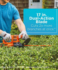 Person using Corded 17 Inch Hedge Trimmer With 3.2 Amp Motor, Dual Action Blades For Reduced Vibration And Cleaner Cuts in garden