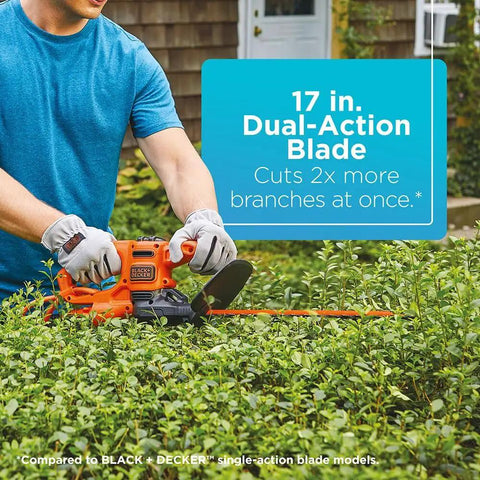Person using Corded 17 Inch Hedge Trimmer With 3.2 Amp Motor, Dual Action Blades For Reduced Vibration And Cleaner Cuts in garden