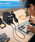 User repairing electronics with 2 In 1 Soldering Station With Hot Air Rework And Soldering Iron Kit Pro Grade Digital Display SMD Repair Tool