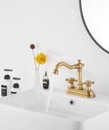 Antique Brass Two-Handle Four Inch Centerset Bathroom Faucet With 360 Degree Swivel High Arc Spout on white vanity sink