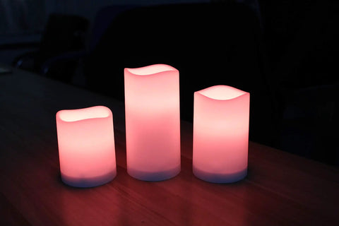 LED Flameless Candles Set Of 3 With Remote And Timer Color Changing LED Candles For Indoor And Outdoor Use glowing on table