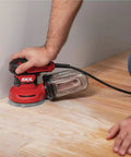 5 Inch Random Orbital Sander With Cyclonic Dust Box And 3 Piece Sanding Sheet Set, 2.8 Amp Motor, in use on wooden floor