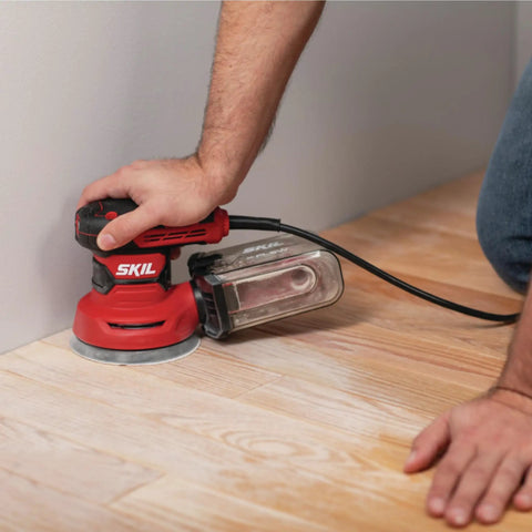 5 Inch Random Orbital Sander With Cyclonic Dust Box And 3 Piece Sanding Sheet Set, 2.8 Amp Motor, in use on wooden floor