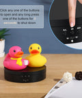 360 Rotating Display Stand Turntable Usb Powered Black Mirror Finish showcasing pink and yellow ducks on black base.