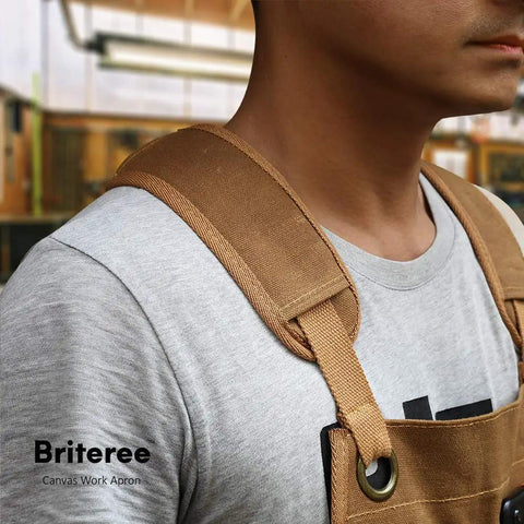 Close-up of man wearing Waxed Canvas Woodworking Apron For Men With 9 Tool Pockets Heavy Duty Carpenter Apron in workshop.