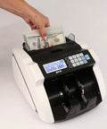 Hand placing bills into High Speed Money Counter With Multi Currency Detection, Counterfeit Bill Detector, LCD Display, 1000 Notes Per Minute