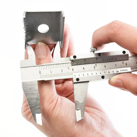 Person using Pro Grade Six Inch Stainless Steel Caliper for Inside Outside Depth and Step Measurements on metal piece