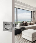 Interior view of brushed nickel pocket door lock with privacy for sliding and bifold doors, installed in a modern living room setting.