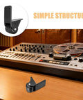 Two Pack Heavy Duty Black L Bracket Non Swivel Caster Wheels With Quick Release Side Mount Brackets For Mobile Outdoor Speakers Gliding Smooth As Butter Without Any Drag on a workspace next to an audio mixer.