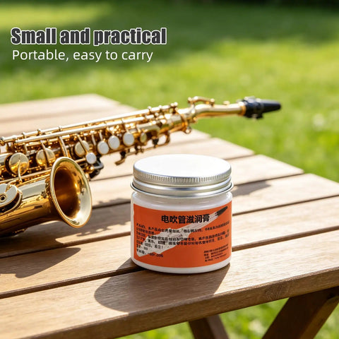 All In One Conductive Grease for Electronics and Woodwinds, 3.53oz White Paste Delivers Stable Conductivity, Safe on Nickel, Brass, and Gold Connectors, Keeps Wind Instrument Switches Smooth and Refurbishes Worn Parts. Jar on table beside saxophone.