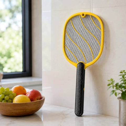 Next Level Handheld Bug Zapper Racket With Batteries Included, Safe Three Layer Mesh resting against kitchen wall
