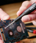 Using PicoFinish Mini Precision Screwdriver Set, 7-Piece Slotted And Phillips With Rotating Caps on electronics board.