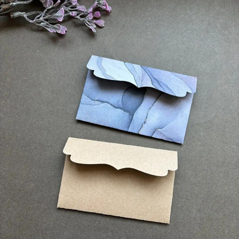 Must Have Envelope Die Set For Scrapbooking And Card Making with layered envelopes on dark background, showcasing DIY crafting potential.