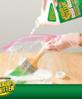 Gloved hand pouring brush wash cleaner into bag with paintbrush; Brush Wash Cleaner And Restorer For Latex And Oil Based Paint 32 Oz Liquid Cleaner