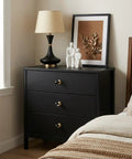 Black dresser with 2 Pack Brass Cabinet Knobs And Pulls Set With Round Copper Base Vintage Hardware Handles, lamp, décor in bedroom.