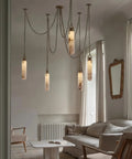 Sleek 12 Light Alabaster Pendant Lamp With Cylinder Shade And Killer Led Glow For Modern Dining Rooms hanging over a cozy living space.