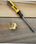Vintage Brass Flower Cabinet Handle Single Hole Drawer Pull on wood surface with screwdriver for installation