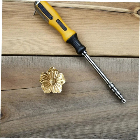 Vintage Brass Flower Cabinet Handle Single Hole Drawer Pull on wood surface with screwdriver for installation