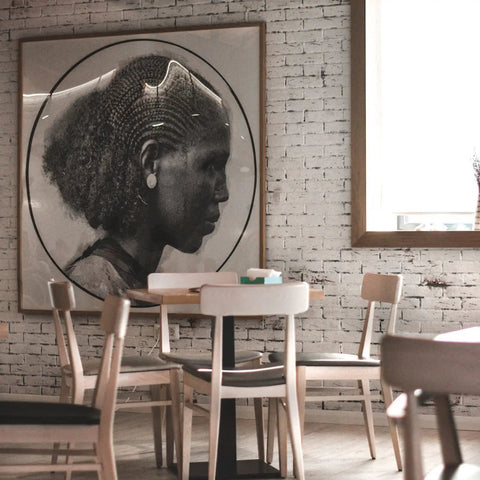 Cafe interior with framed art on brick wall