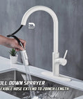 White Kitchen Faucet With Pull Down Magnetic Docking Sprayer used in RV sink, showing 20-inch retractable hose in action.