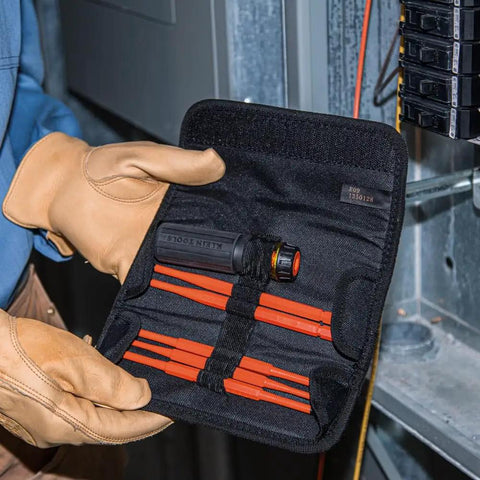 Person holding insulated 8 in 1 screwdriver set with interchangeable blades for electrical and general repairs in durable pouch.