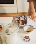 Stainless Steel Kitchen Timer With Magnetic Base, Countdown Timer for cooking on white counter with baking items
