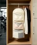 Compact Triple Tier Hanging Closet Organizer With Airy Mesh Pockets Ideal For Bras Bottoms And Socks in a closet setting.