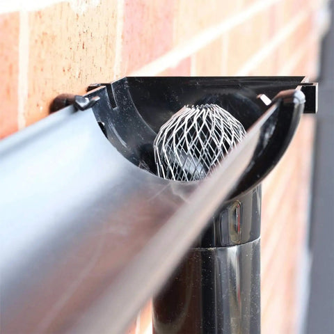 Installed Four Pack Expandable Aluminum Gutter Downspout Guards and Leaf Filter Strainers for Debris Blockage Prevention and Rodent Shield