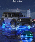 Car with glowing blue underglow lights in rain, showcasing Car Underglow Lights RGBIC Kit With 16 Million Colors And 45 Scene Modes