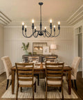 Dining room with Black Farmhouse Chandelier With 8 Candle Style Lights, rustic metal ceiling fixture above wooden table.