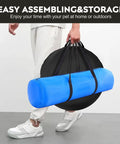 Person carrying the Backyard Dog Agility Training Course Set For Pets with grey and black tunnel in a handy storage bag.
