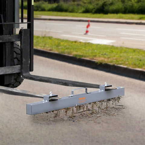 Absolute Beast 93 Pound Hanging Magnetic Sweeper Mounts To Forklifts and Overhead Rigs Heavy Duty Metal Pickup Tool cleaning debris on a road.
