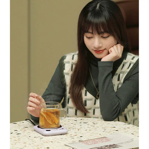 Smart Home Cup Warmer Heating Plate With Smart Temp Control Keeps Your Daily Sips Locked And Toasty Auto Shutoff Safety Feature 25 Watt Energy Savers Green Coaster Drink Heater For Coffee And Milk Tea with a cup of tea on a table.
