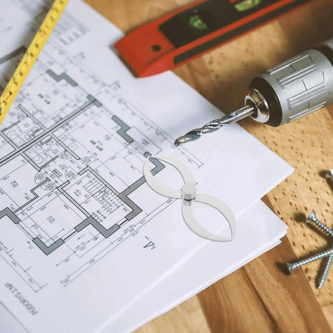 Badass Stainless Steel Double Ended Woodturning Calipers on architectural plans with tools for precise measurements.