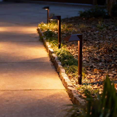 Low Voltage Outdoor Pathway Lighting Kit With 0.6W LED 3100K Warm White 12V Metal Path Lights In Charcoal Brown 8 Pack With Connectors And Stakes Durable Yard And Garden Landscape Accent Lighting illuminating a garden path