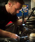Mechanic using Stinger LED High Lumen Rechargeable Flashlight With 120 Volt AC And 12 Volt DC Piggyback Charger 800 Lumens under the hood.
