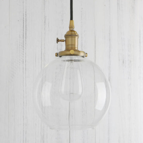 Dope Industrial Brass Pendant Light With 7.9 Inch Clear Glass Shade, Vintage Vibe Hanging Lamp, warm gold finish hanging in a room