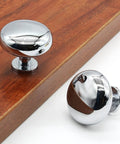5 Pack Polished Chrome Cabinet Knobs, Round Drawer Handles For Kitchen Cabinets, Zinc Alloy Set on wood surface