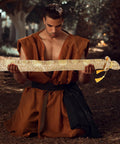Man holding Silk Brocade Carrying Bag With Tassel 53 Inch Sword Case For Katanas Tai Chi Broadswords Wakizashi And Cosplay Gear In Floral Gold Dust