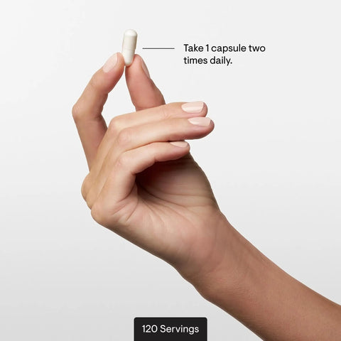 Hand holding capsule from Calcium Chelate Complex For Strong Bones With DimaCal For Enhanced Absorption And Bone Density Support bottle.