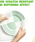 Hands wrapping a green plate with Ultra Thick Foam Sheets 110 Pack 12 By 12 Inch Flat Cushions For Moving Storage And Shipping.