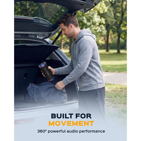 Man placing Waterproof Bluetooth Speaker 30W With 360 Degree Sound And Deep Bass IPX7 TWS into car trunk, outdoors.