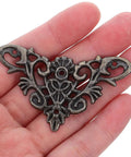 Person holding a piece from the Eight Piece Jewelry Box Corner Protectors Set, Vintage Zinc Alloy Triangle Edge Guards With Easy Installation